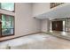 Bright living room featuring large windows, staircase, and entryway at 102 Wild Plum Ln, Longwood, FL 32779