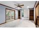 Spacious living room features built-in shelves, ceiling fan, and french doors to outside at 102 Wild Plum Ln, Longwood, FL 32779