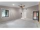 Expansive primary bedroom featuring a ceiling fan, neutral paint, trim, and multiple doorways leading to the closets and bathroom at 102 Wild Plum Ln, Longwood, FL 32779