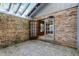 Outdoor brick patio with brick wall and glass doors at 102 Wild Plum Ln, Longwood, FL 32779