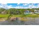 Stunning waterfront estate featuring a private boat dock, lush landscaping, and luxurious architectural design at 10577 Down Lakeview Cir, Windermere, FL 34786