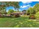 This backyard offers expansive green space, professional landscaping, and views of the luxury home at 10577 Down Lakeview Cir, Windermere, FL 34786