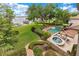 Landscaped backyard showcasing a pool, spa, manicured lawn, and lake views at 10577 Down Lakeview Cir, Windermere, FL 34786