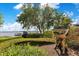This backyard features professional landscaping, mature trees, and a stone wall with views of the lake at 10577 Down Lakeview Cir, Windermere, FL 34786