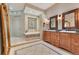 Bathroom with large vanity, soaking tub, and neutral tile work at 10577 Down Lakeview Cir, Windermere, FL 34786