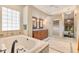 Luxurious bathroom with soaking tub, double vanity, tile shower, and large window at 10577 Down Lakeview Cir, Windermere, FL 34786