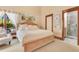 Bright bedroom featuring a sitting chair, closet, and en suite bath at 10577 Down Lakeview Cir, Windermere, FL 34786