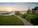 Picturesque lake view featuring a charming dock, boat house, and lush green surroundings at 10577 Down Lakeview Cir, Windermere, FL 34786