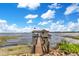 Charming dock house featuring a weathered dock and clear blue skies at 10577 Down Lakeview Cir, Windermere, FL 34786