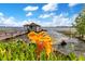 Close-up shot of a charming dock house with vibrant flowers in the foreground at 10577 Down Lakeview Cir, Windermere, FL 34786