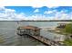 Aerial view of a boat dock with a charming dock house under a clear blue sky at 10577 Down Lakeview Cir, Windermere, FL 34786
