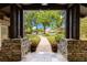 Grand entryway with stone pillars and a beautifully landscaped view, creating an inviting and elegant entrance at 10577 Down Lakeview Cir, Windermere, FL 34786