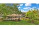 Expansive backyard with manicured lawn, mature trees, and a sparkling pool, perfect for relaxation and outdoor entertainment at 10577 Down Lakeview Cir, Windermere, FL 34786