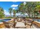 Outdoor seating area surrounding fire pit, with lake views in the background at 10577 Down Lakeview Cir, Windermere, FL 34786