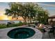 Relax by the firepit and spa overlooking tranquil lake views in this luxurious outdoor space at 10577 Down Lakeview Cir, Windermere, FL 34786