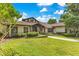 Charming home featuring a lush lawn, professional landscaping, and a brick pathway leading to the front door at 10577 Down Lakeview Cir, Windermere, FL 34786