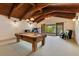 Spacious game room featuring exposed wood beams, a pool table, and comfortable seating for entertainment at 10577 Down Lakeview Cir, Windermere, FL 34786