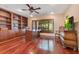 Inviting home office with custom wood built-ins, desk, and large windows offering natural light and views at 10577 Down Lakeview Cir, Windermere, FL 34786