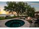 Relaxing hot tub and fire pit area with comfortable seating, perfect for enjoying the serene lake view at 10577 Down Lakeview Cir, Windermere, FL 34786