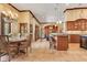 Open concept kitchen with an island bar and custom cabinetry flowing into the dining area, great for entertaining at 10577 Down Lakeview Cir, Windermere, FL 34786