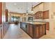 Gourmet kitchen featuring a large center island, custom cabinetry, and a view of the adjacent dining area at 10577 Down Lakeview Cir, Windermere, FL 34786