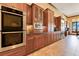 State-of-the-art kitchen featuring stainless steel appliances, custom wood cabinetry, and tile backsplash at 10577 Down Lakeview Cir, Windermere, FL 34786