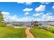 Picturesque lakeside view with a charming dock house and lush green lawn leading to the water at 10577 Down Lakeview Cir, Windermere, FL 34786