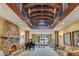 Large living space with stone fireplace, piano, and view to dining area with lake view at 10577 Down Lakeview Cir, Windermere, FL 34786