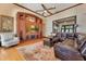 Inviting living area featuring a custom built-in entertainment center, hardwood floors, and ample seating at 10577 Down Lakeview Cir, Windermere, FL 34786