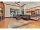Comfortable living room featuring hardwood floors, ceiling fan, and ample space for seating at 10577 Down Lakeview Cir, Windermere, FL 34786