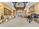 Spacious living room featuring a piano, fireplace, and entryway at 10577 Down Lakeview Cir, Windermere, FL 34786
