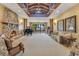 Elegant living room with a stone fireplace, grand piano, and lake views, perfect for relaxation and entertaining at 10577 Down Lakeview Cir, Windermere, FL 34786