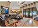 Expansive living room featuring hardwood floors, coffered ceilings, and access to the patio with water views at 10577 Down Lakeview Cir, Windermere, FL 34786