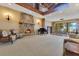 Expansive living room with stone fireplace, piano, and dining area with water view at 10577 Down Lakeview Cir, Windermere, FL 34786