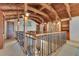 Upper loft area featuring wood beam architecture, stone accent wall and wrought iron railings at 10577 Down Lakeview Cir, Windermere, FL 34786