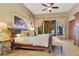 Bright main bedroom featuring a ceiling fan, seating at the end of the bed, and lots of natural light at 10577 Down Lakeview Cir, Windermere, FL 34786