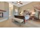 Serene main bedroom with a cozy fireplace, soft carpet, and ample natural light at 10577 Down Lakeview Cir, Windermere, FL 34786