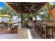 Outdoor kitchen features stone accents, a pizza oven, bar seating, and scenic lake views at 10577 Down Lakeview Cir, Windermere, FL 34786