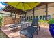 Relaxing outdoor seating area with shade umbrella, outdoor kitchen and built-in seating offers scenic views at 10577 Down Lakeview Cir, Windermere, FL 34786
