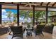 Comfortable outdoor living space with wicker furniture, lake views, and lush landscaping at 10577 Down Lakeview Cir, Windermere, FL 34786