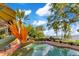 Pool and view of lush tropical backyard overlooking the lake at 10577 Down Lakeview Cir, Windermere, FL 34786