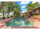 Inviting pool area with brick patio, outdoor kitchen, and lush landscaping offers a perfect retreat at 10577 Down Lakeview Cir, Windermere, FL 34786