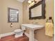 Stylish powder room with elegant pedestal sink, framed mirror, and modern fixtures at 10577 Down Lakeview Cir, Windermere, FL 34786