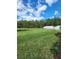 Wide open backyard with an expansive lawn and pond at 1134 Pando Loop, Orlando, FL 32824
