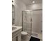 Bathroom featuring white tiled shower, toilet, and vanity with modern fixtures at 1134 Pando Loop, Orlando, FL 32824