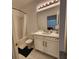 Bright bathroom featuring a tub with shower, toilet, vanity and large mirror at 1134 Pando Loop, Orlando, FL 32824