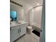 Bright bathroom with white tiled shower, vanity and large mirror at 1134 Pando Loop, Orlando, FL 32824