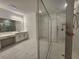 Bright bathroom features white cabinetry, marble-like tile, and a large glass shower with white penny tile flooring at 1134 Pando Loop, Orlando, FL 32824