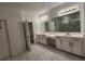 Modern bathroom featuring dual sinks, shower and quartz counters at 1134 Pando Loop, Orlando, FL 32824