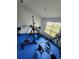 This is a home gym with blue tile, weights, and lots of equipment and weights at 1134 Pando Loop, Orlando, FL 32824